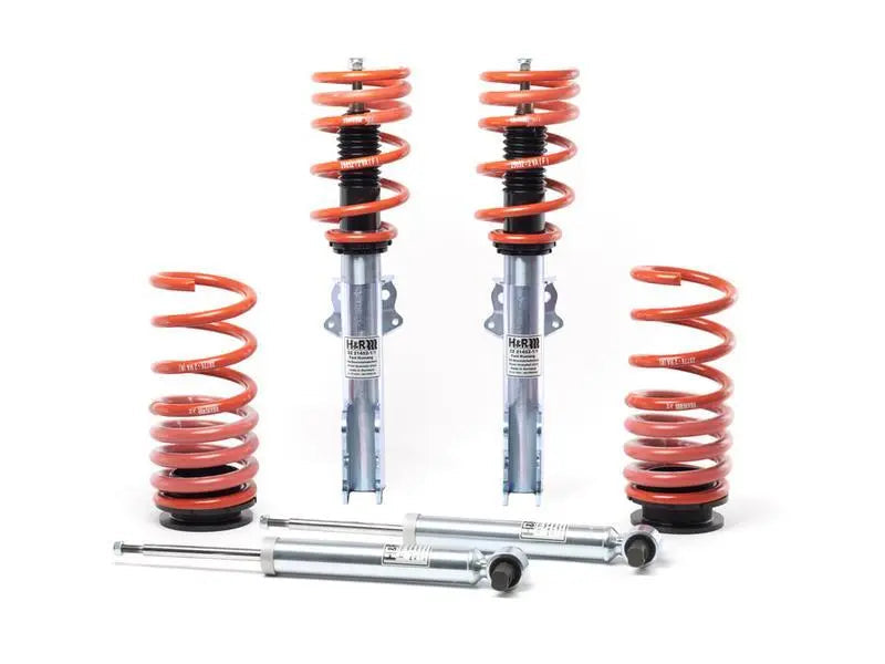 Set of suspension components including springs and shock absorbers on a white background