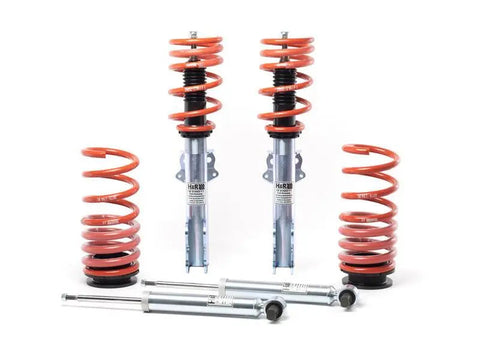 Set of suspension components including springs and shock absorbers on a white background